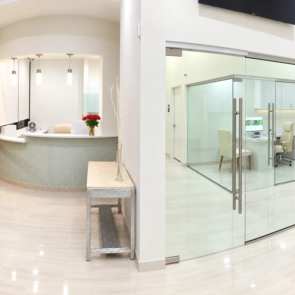Reception desk beside glass doors to the consultation office