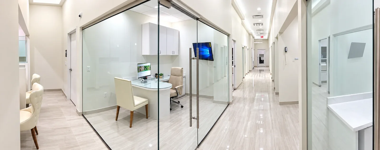 Hallway lined with glass-walled offices